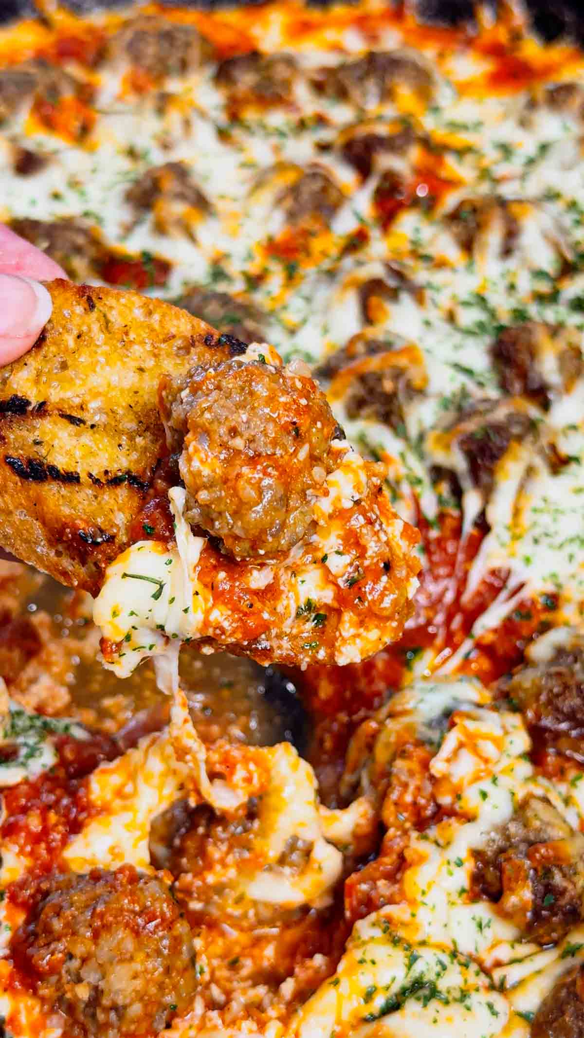 This Meatball Sub Dip is everything you love about a classic meatball sub, baked into a hot, cheesy skillet dip that’s perfect for sharing. Loaded with homemade tiny meatballs, creamy ricotta, rich pasta sauce, and plenty of shredded mozzarella, this easy baked dip comes out bubbly, melty, and packed with hearty Italian flavor. Serve it with sliced, toasted baguette for dipping to make every bite taste just like a warm, cheesy meatball sub—perfect for game day, parties, or any casual get-together.