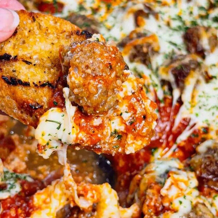 This Meatball Sub Dip is everything you love about a classic meatball sub, baked into a hot, cheesy skillet dip that’s perfect for sharing. Loaded with homemade tiny meatballs, creamy ricotta, rich pasta sauce, and plenty of shredded mozzarella, this easy baked dip comes out bubbly, melty, and packed with hearty Italian flavor. Serve it with sliced, toasted baguette for dipping to make every bite taste just like a warm, cheesy meatball sub—perfect for game day, parties, or any casual get-together.