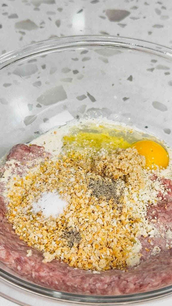 ground beef, bread crumbs, milk, egg and spices in a mixing bowl