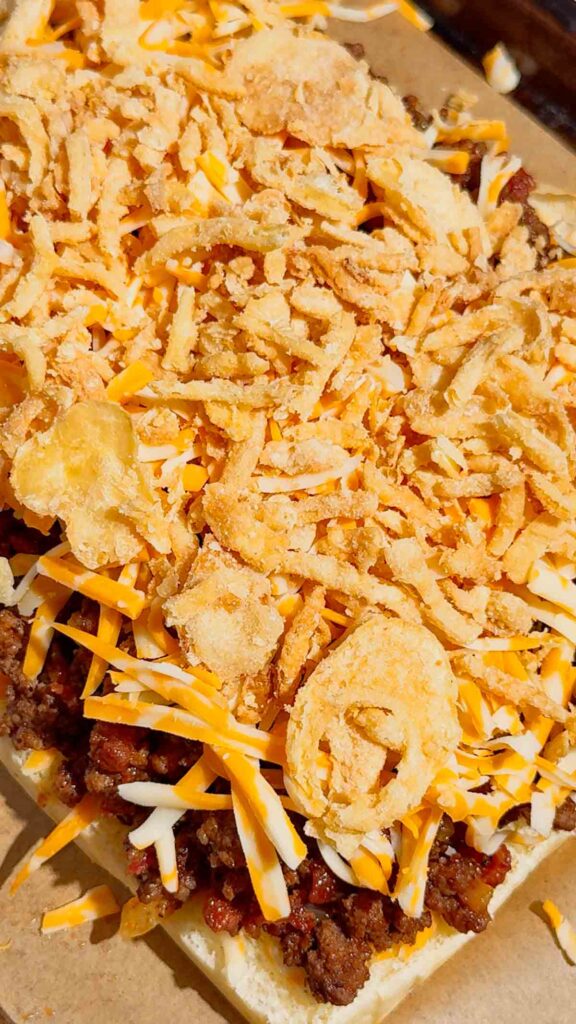 crispy fried onions on top of shredded cheese and ground beef mixture