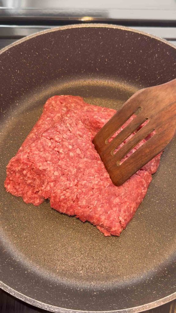 raw ground beef in a skillet