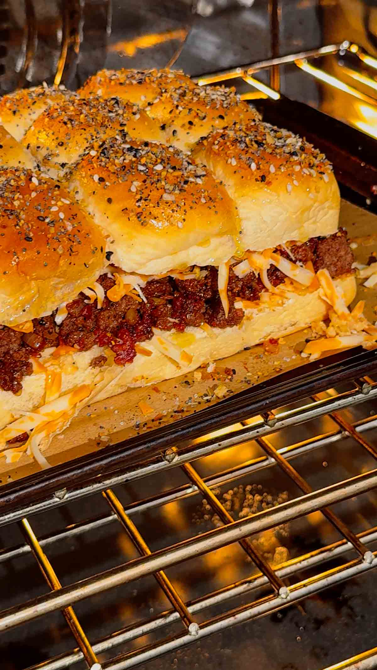 bbq bacon cheeseburger sliders baking in the oven