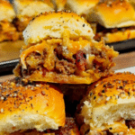 BBQ Bacon Cheeseburger Sliders are the ultimate easy dinner or party food! Juicy ground beef, diced onions, crumbled bacon, and BBQ sauce piled onto buttery King’s Hawaiian rolls, topped with shredded cheddar, crispy fried onions, and everything bagel seasoning. Perfect for game day, potlucks, weeknight dinners, or crowd-pleasing appetizers. Save this cheesy slider recipe! 🍔🔥