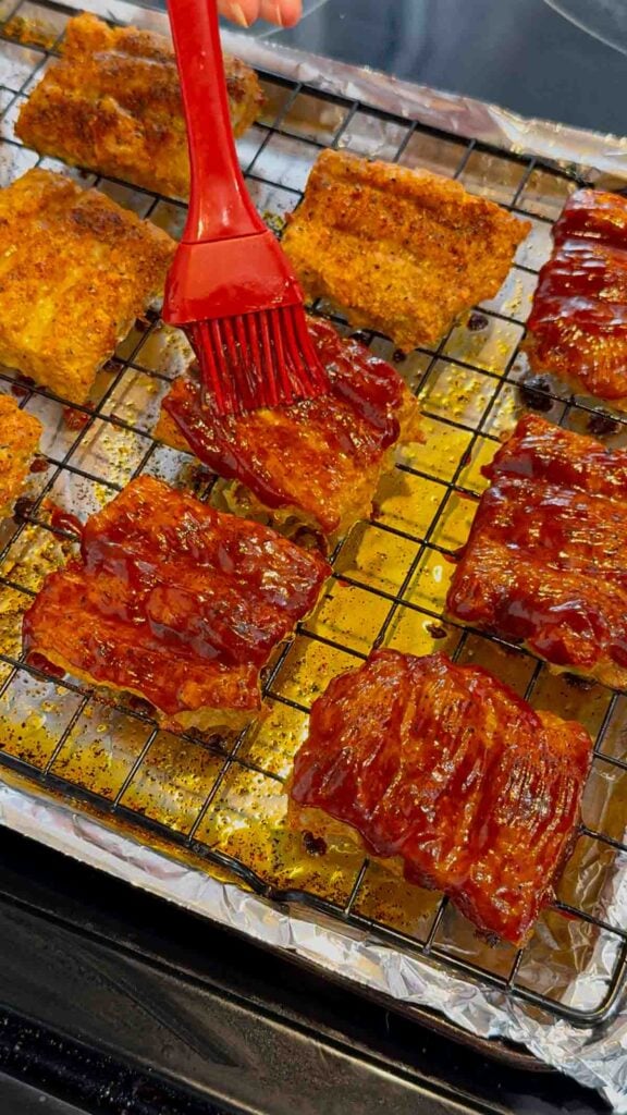 brushing bbq sauce on mini mcrib patties