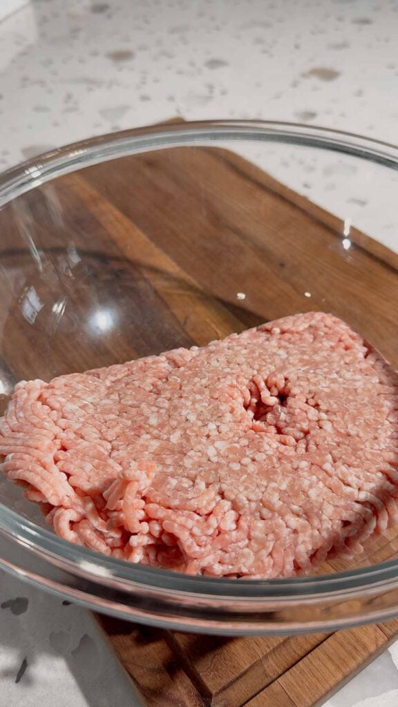 raw ground pork in a glass bowl