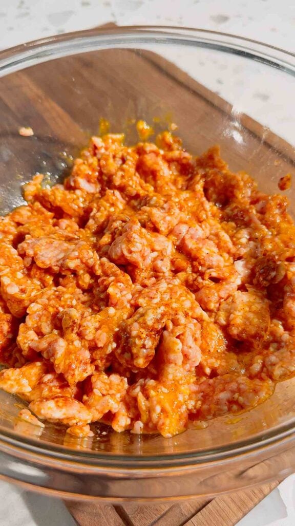 ground pork, egg and bbq seasoning mixture in a glass bowl