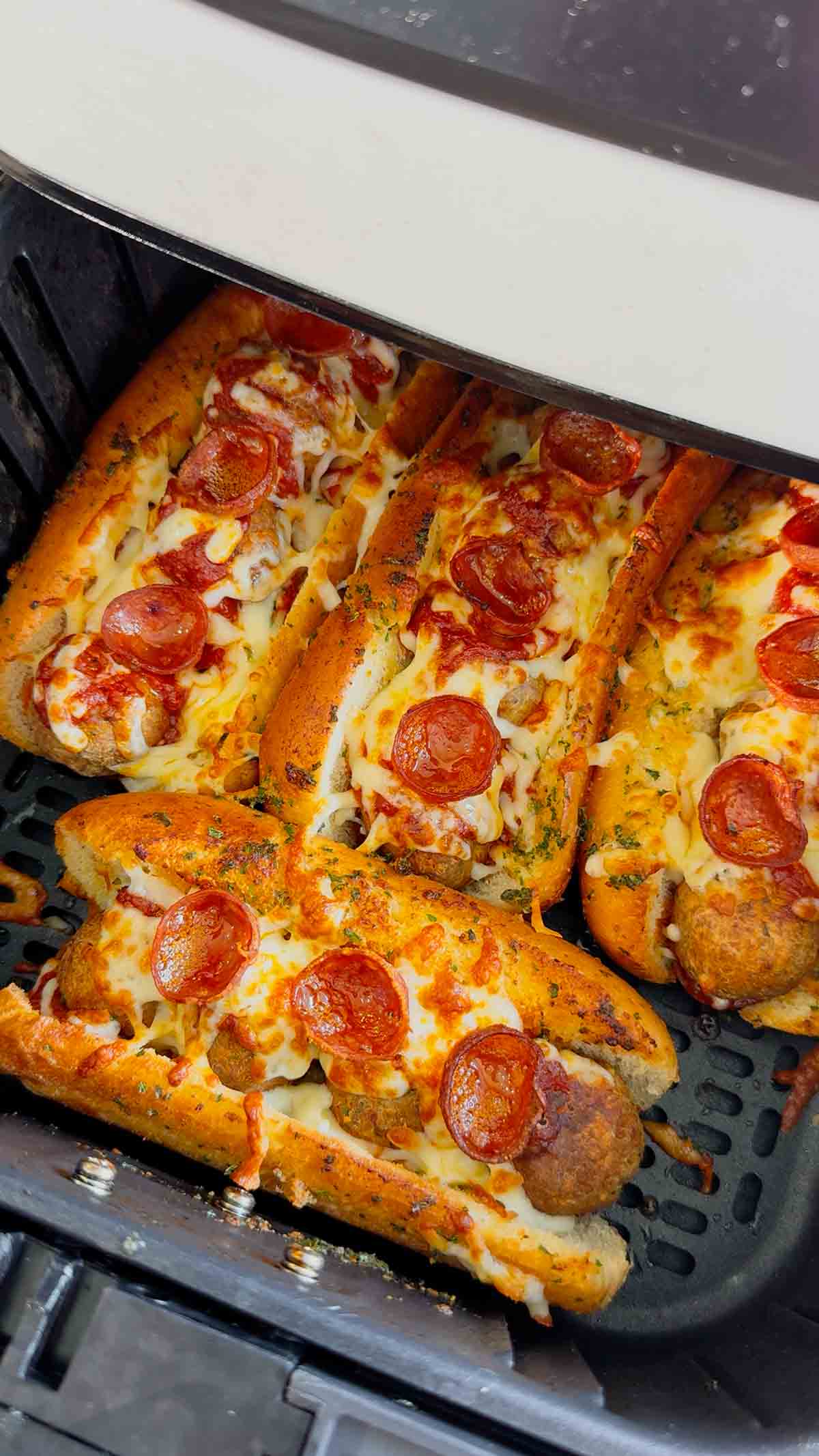 These Air Fryer Pizza Meatball Subs are the ultimate easy comfort food dinner for busy weeknights, game day snacks and picky eaters. Made with frozen meatballs, pizza sauce, pepperoni, mozzarella cheese and buttery toasted hot dog buns, this easy air fryer recipe tastes just like a cheesy pepperoni pizza sub from your favourite restaurant. Perfect for quick family dinners, easy air fryer meals, meatball sandwich recipes, pizza sandwich ideas and kid friendly dinners, these toasted subs come together fast with minimal prep. If you are looking for easy dinner recipes for family, air fryer sandwich recipes, hot sandwich ideas, meatball sub recipes or fun weeknight dinner ideas, these crispy cheesy pizza subs are always a hit.