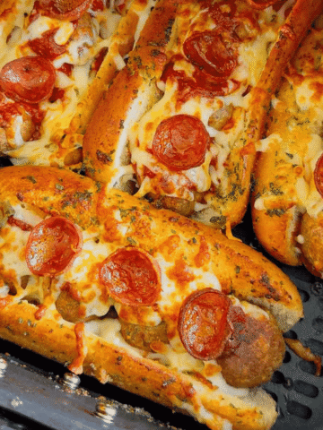 These Air Fryer Pizza Meatball Subs are the ultimate easy comfort food dinner for busy weeknights, game day snacks and picky eaters. Made with frozen meatballs, pizza sauce, pepperoni, mozzarella cheese and buttery toasted hot dog buns, this easy air fryer recipe tastes just like a cheesy pepperoni pizza sub from your favourite restaurant. Perfect for quick family dinners, easy air fryer meals, meatball sandwich recipes, pizza sandwich ideas and kid friendly dinners, these toasted subs come together fast with minimal prep. If you are looking for easy dinner recipes for family, air fryer sandwich recipes, hot sandwich ideas, meatball sub recipes or fun weeknight dinner ideas, these crispy cheesy pizza subs are always a hit.