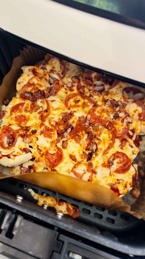 Air Fryer Pizza Pierogies are the ultimate easy comfort food recipe for busy weeknights, game day snacks, party appetizers and lazy dinners. Frozen bacon pierogies are air fried until crispy and golden, then topped with pizza sauce, shredded mozzarella cheese, pepperoni and crumbled bacon for a cheesy pizza-inspired dinner everyone will love. This easy air fryer recipe is perfect for picky eaters, quick meals, easy dinner ideas, air fryer snacks and fun family dinners. If you love pizza recipes, frozen pierogi recipes, cheesy appetizers, easy air fryer dinners, quick comfort food and crispy air fryer recipes, these loaded pizza pierogies are a must-try for your next weeknight meal, movie night snack or game day party food spread.