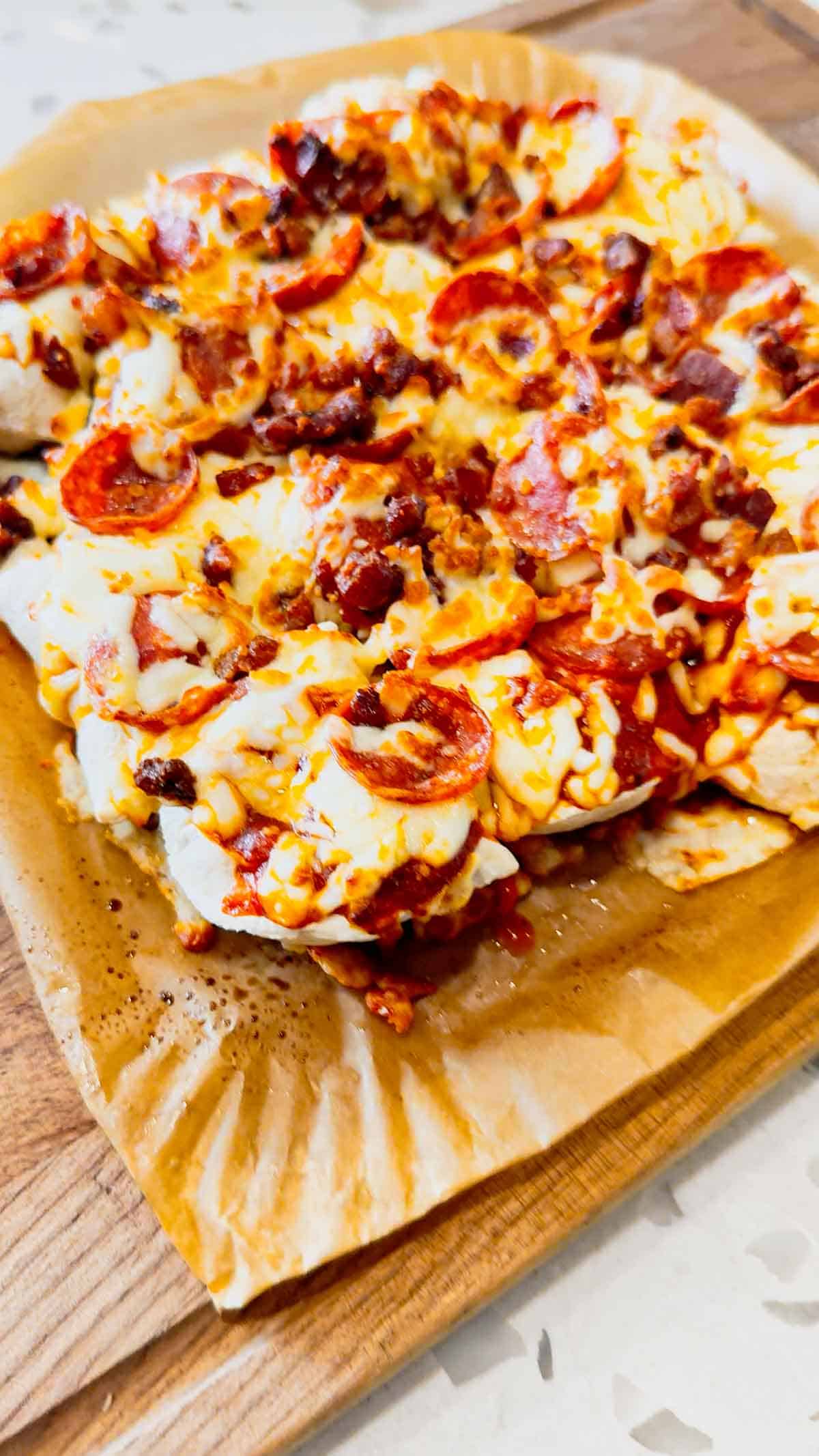 Air Fryer Pizza Pierogies are the ultimate easy comfort food recipe for busy weeknights, game day snacks, party appetizers and lazy dinners. Frozen bacon pierogies are air fried until crispy and golden, then topped with pizza sauce, shredded mozzarella cheese, pepperoni and crumbled bacon for a cheesy pizza-inspired dinner everyone will love. This easy air fryer recipe is perfect for picky eaters, quick meals, easy dinner ideas, air fryer snacks and fun family dinners. If you love pizza recipes, frozen pierogi recipes, cheesy appetizers, easy air fryer dinners, quick comfort food and crispy air fryer recipes, these loaded pizza pierogies are a must-try for your next weeknight meal, movie night snack or game day party food spread.