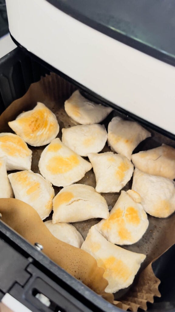 browned pierogies in an air fryer basket