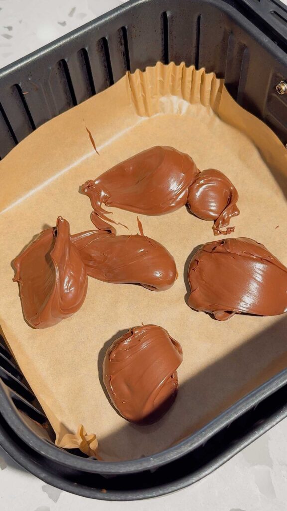 globs of Nutella dropped into an air fryer basket liner