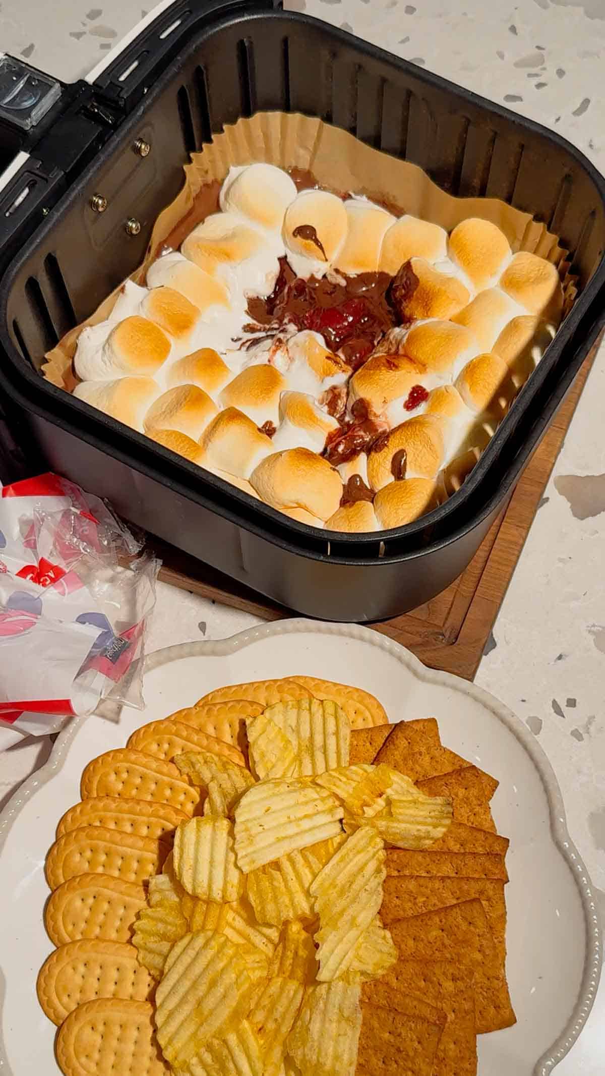 This Air Fryer Strawberry Nutella S’mores Dip is the ultimate easy dessert recipe for chocolate lovers, summer parties and cozy movie nights at home. Made with creamy Nutella, sweet strawberry pie filling and gooey toasted marshmallows, this air fryer dessert is a fun twist on classic campfire s’mores without needing a fire pit. Serve it warm with graham crackers, cookies, pretzels or fresh strawberries for the perfect sweet snack, party dessert or quick treat idea. If you love easy air fryer recipes, dessert dips, viral TikTok desserts, chocolate strawberry desserts, marshmallow treats and fun family dessert ideas, this easy s’mores dip recipe is a must try for sleepovers, date nights, birthday parties, holiday gatherings and summer entertaining.