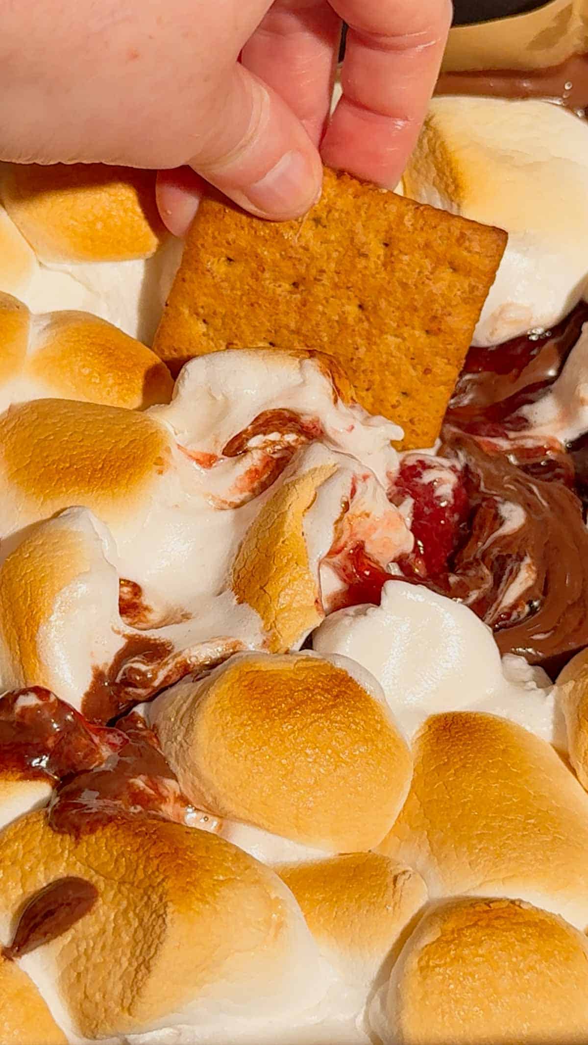 This Air Fryer Strawberry Nutella S’mores Dip is the ultimate easy dessert recipe for chocolate lovers, summer parties and cozy movie nights at home. Made with creamy Nutella, sweet strawberry pie filling and gooey toasted marshmallows, this air fryer dessert is a fun twist on classic campfire s’mores without needing a fire pit. Serve it warm with graham crackers, cookies, pretzels or fresh strawberries for the perfect sweet snack, party dessert or quick treat idea. If you love easy air fryer recipes, dessert dips, viral TikTok desserts, chocolate strawberry desserts, marshmallow treats and fun family dessert ideas, this easy s’mores dip recipe is a must try for sleepovers, date nights, birthday parties, holiday gatherings and summer entertaining.