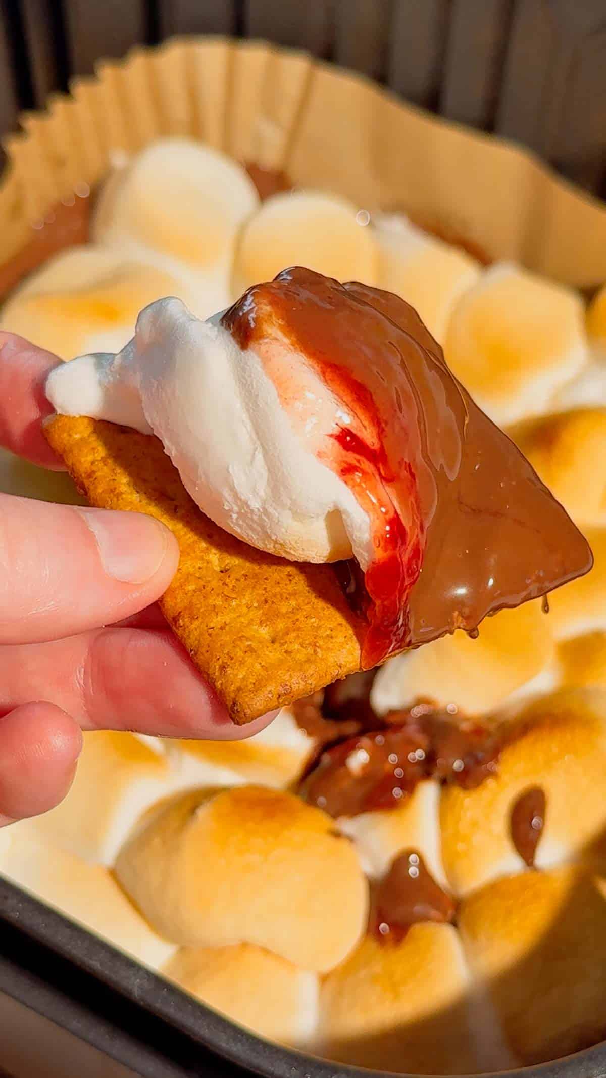 This Air Fryer Strawberry Nutella S’mores Dip is the ultimate easy dessert recipe for chocolate lovers, summer parties and cozy movie nights at home. Made with creamy Nutella, sweet strawberry pie filling and gooey toasted marshmallows, this air fryer dessert is a fun twist on classic campfire s’mores without needing a fire pit. Serve it warm with graham crackers, cookies, pretzels or fresh strawberries for the perfect sweet snack, party dessert or quick treat idea. If you love easy air fryer recipes, dessert dips, viral TikTok desserts, chocolate strawberry desserts, marshmallow treats and fun family dessert ideas, this easy s’mores dip recipe is a must try for sleepovers, date nights, birthday parties, holiday gatherings and summer entertaining.