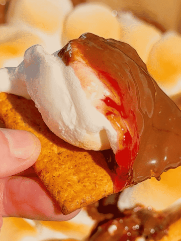 This Air Fryer Strawberry Nutella S’mores Dip is the ultimate easy dessert recipe for chocolate lovers, summer parties and cozy movie nights at home. Made with creamy Nutella, sweet strawberry pie filling and gooey toasted marshmallows, this air fryer dessert is a fun twist on classic campfire s’mores without needing a fire pit. Serve it warm with graham crackers, cookies, pretzels or fresh strawberries for the perfect sweet snack, party dessert or quick treat idea. If you love easy air fryer recipes, dessert dips, viral TikTok desserts, chocolate strawberry desserts, marshmallow treats and fun family dessert ideas, this easy s’mores dip recipe is a must try for sleepovers, date nights, birthday parties, holiday gatherings and summer entertaining.