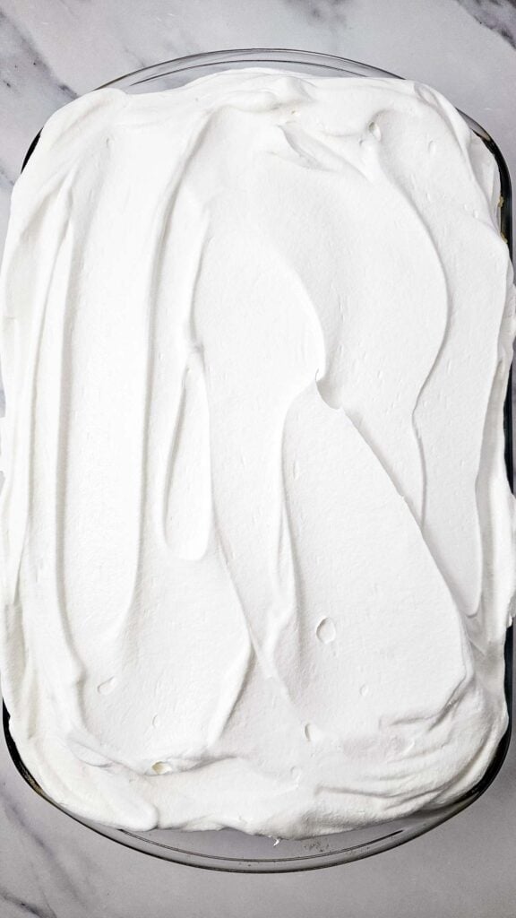 whipped topping spread over cake