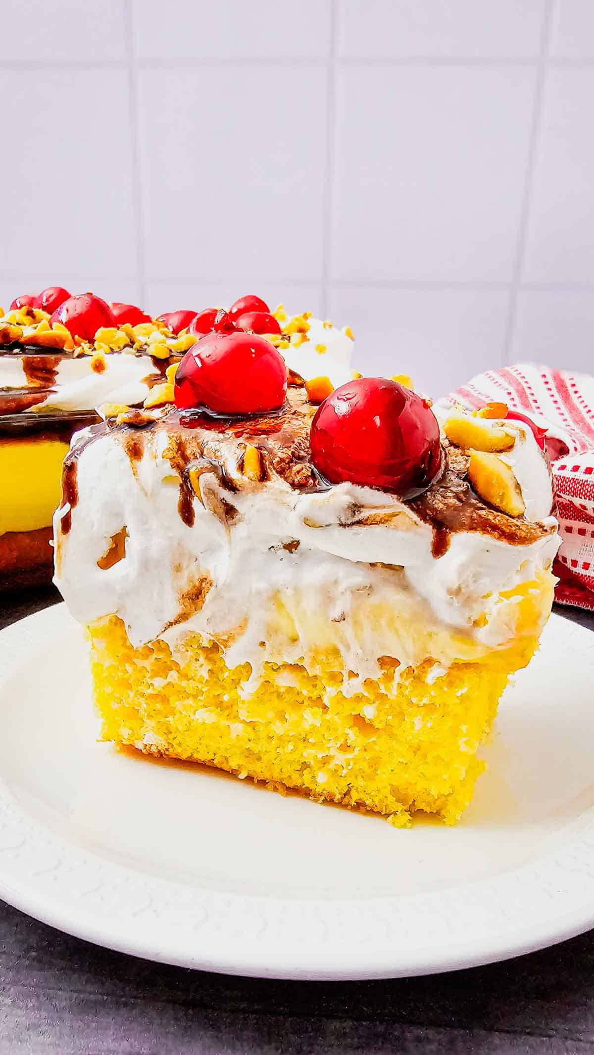 Banana Split Cake is the ultimate easy dessert recipe for anyone who loves classic banana split flavors in a soft baked cake. This layered dessert starts with a moist yellow cake base and is topped with bananas, crushed pineapple, fluffy whipped topping, chocolate drizzle, and maraschino cherries for the perfect sweet finish. If you’re searching for easy cake recipes, banana desserts, pineapple desserts, potluck desserts, summer desserts, or crowd pleasing party desserts, this Banana Split Cake recipe is a must-try. Great for birthdays, BBQs, family gatherings, holidays, and make ahead desserts, this colorful treat is simple to prepare and always a hit with both kids and adults who love fun retro dessert recipes.
