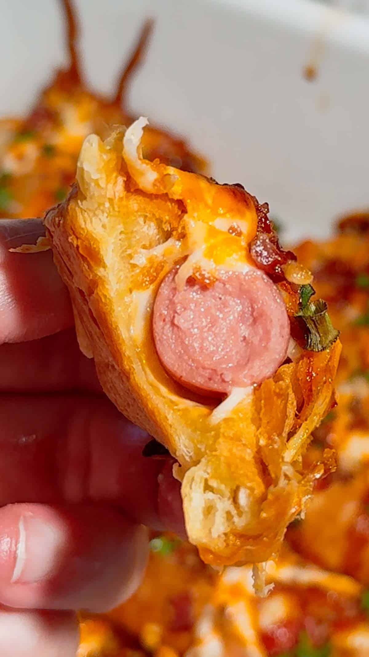 Looking for the ultimate easy party appetizer? These Cheesy Bacon Mini Croissant Dogs are loaded with smoky bacon, melty cheddar cheese, cocktail wieners and BBQ sauce baked inside buttery mini croissants for the perfect bite-sized snack. This easy appetizer recipe is perfect for game day food, football parties, holiday appetizers, movie night snacks and fun family dinners. Using store bought mini croissants keeps this recipe quick, simple and packed with comfort food flavor. If you love pigs in a blanket, cheesy hot dog recipes, bacon appetizers, easy finger foods and crowd pleasing party snacks, these loaded mini croissant dogs are a must-try recipe everyone will be grabbing straight from the pan for seconds.