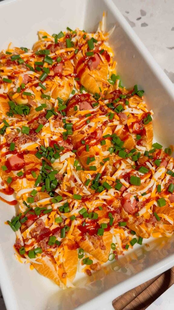 chives, shredded cheese, bbq sauce and bacon on top of mini croissant dogs