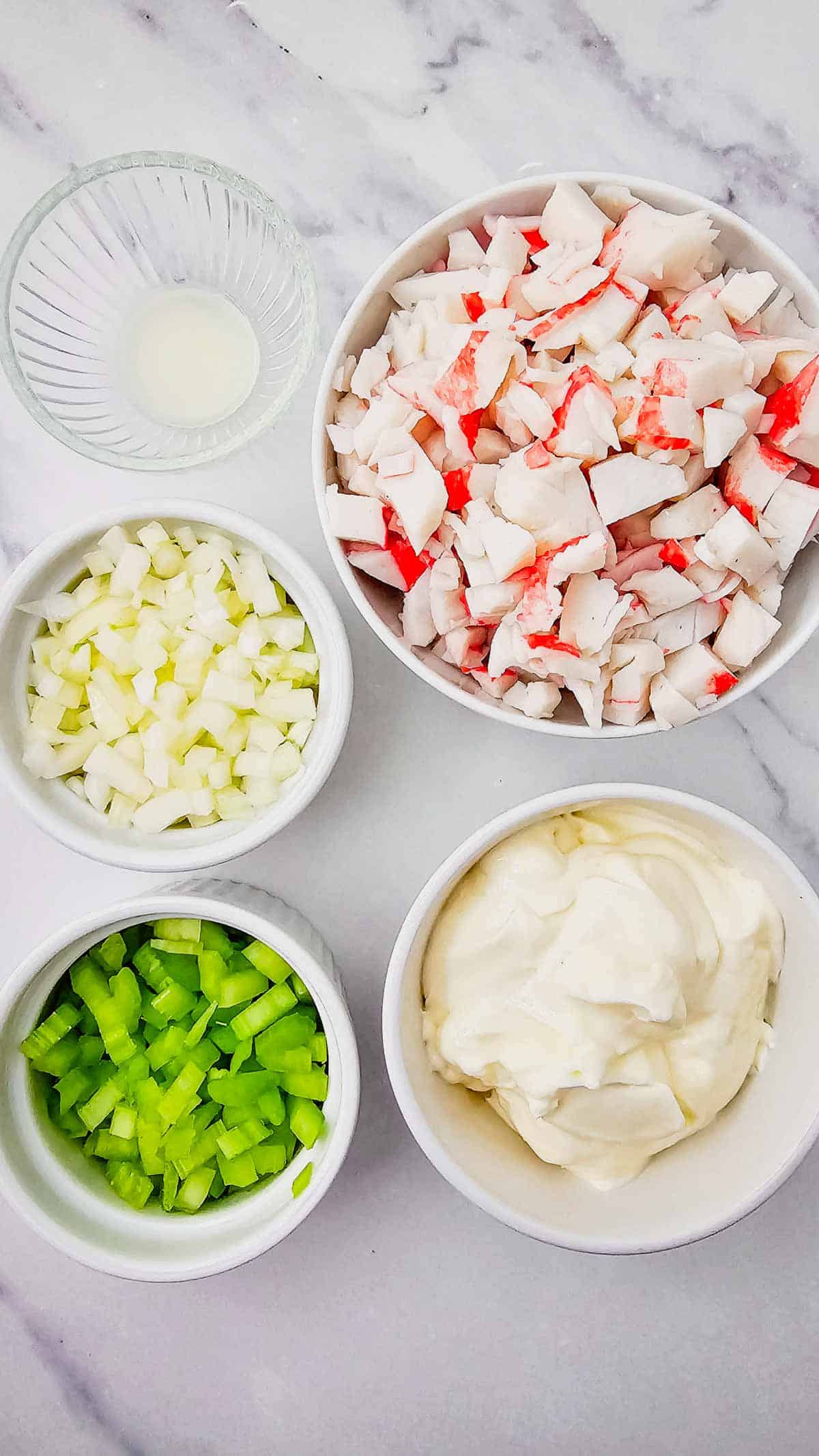 crab salad ingredients in prep bowls