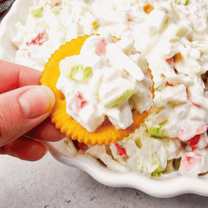 Cold Crab Salad is the easy chilled seafood recipe you’ll want to make all summer long. This creamy crab salad is loaded with imitation crab, crunchy celery, onions and a flavorful dressing for the perfect light lunch, party appetizer or quick dinner idea. Serve it with crackers, pile it onto sandwich rolls, stuff it into croissants or enjoy it straight from the bowl for an easy no cook meal. This cold crab salad recipe is perfect for potlucks, picnics, BBQs, beach lunches and meal prep because it comes together fast with simple ingredients. If you love easy seafood salad recipes, crab salad sandwiches, cold lunch ideas and refreshing summer recipes, this creamy imitation crab salad is guaranteed to become a family favorite.