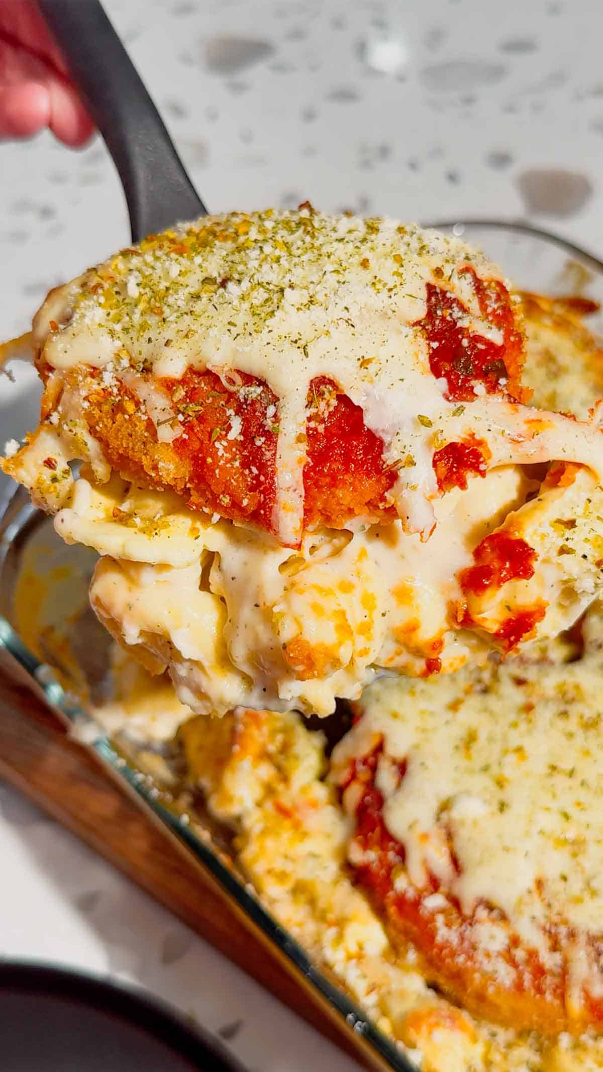 This Dump and Bake Chicken Parm Tortellini Alfredo is the ultimate easy comfort food dinner for busy weeknights, lazy dinners and family meals everyone will love. Made with refrigerated cheese and bacon tortellini, creamy jarred Alfredo sauce, crispy breaded chicken burgers, rich marinara sauce and gooey melted mozzarella, this baked pasta casserole comes together in one dish with almost no prep. If you love easy chicken parm recipes, dump dinners, baked tortellini recipes, cheesy pasta casseroles and simple family dinner ideas, this recipe is a must-try. Perfect for quick weeknight dinners, freezer meals, potlucks and cozy comfort food cravings, this creamy chicken parmesan tortellini bake is loaded with flavour, cheesy layers and hearty pasta goodness in every bite.