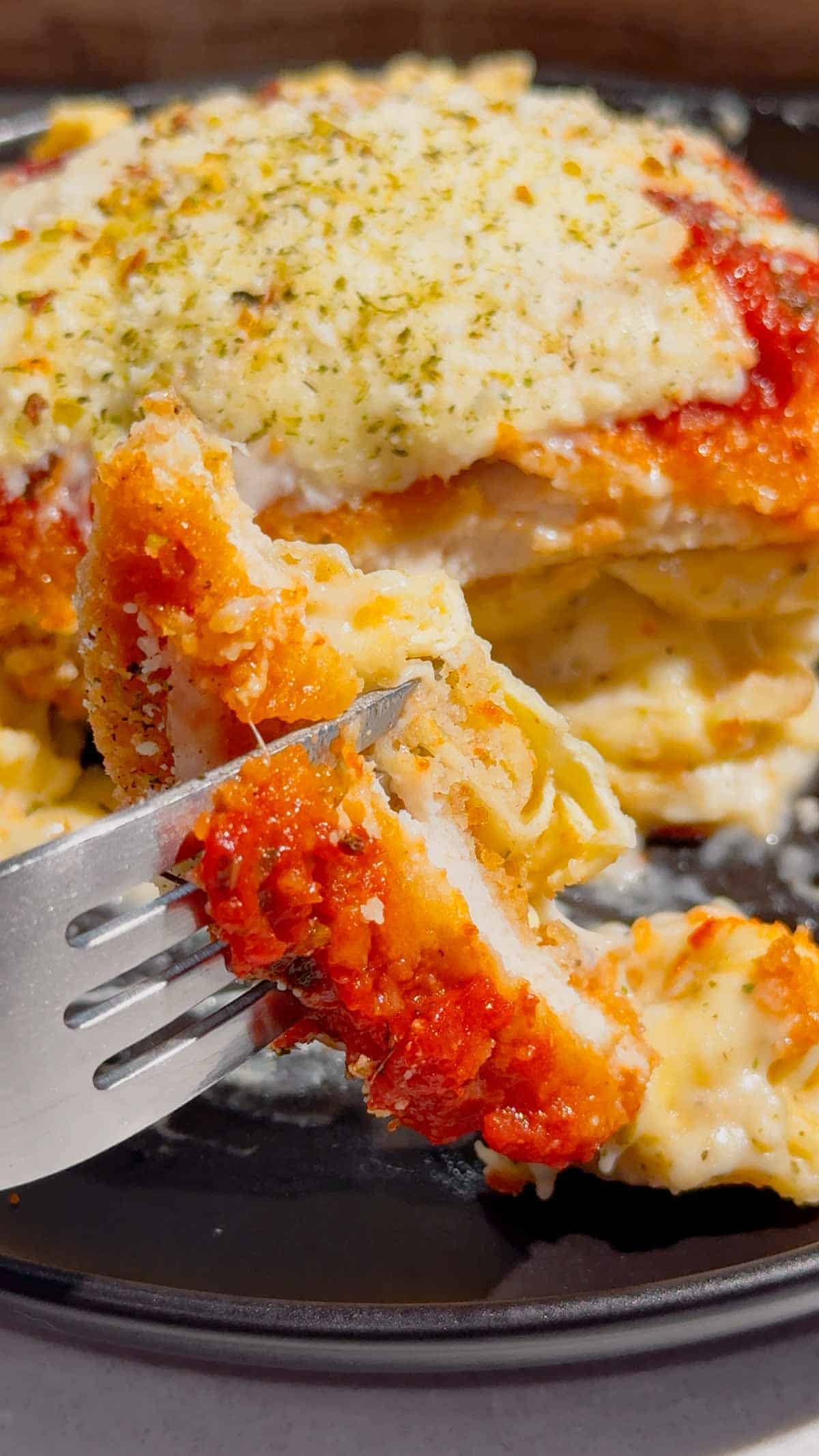 This Dump and Bake Chicken Parm Tortellini Alfredo is the ultimate easy comfort food dinner for busy weeknights, lazy dinners and family meals everyone will love. Made with refrigerated cheese and bacon tortellini, creamy jarred Alfredo sauce, crispy breaded chicken burgers, rich marinara sauce and gooey melted mozzarella, this baked pasta casserole comes together in one dish with almost no prep. If you love easy chicken parm recipes, dump dinners, baked tortellini recipes, cheesy pasta casseroles and simple family dinner ideas, this recipe is a must-try. Perfect for quick weeknight dinners, freezer meals, potlucks and cozy comfort food cravings, this creamy chicken parmesan tortellini bake is loaded with flavour, cheesy layers and hearty pasta goodness in every bite.
