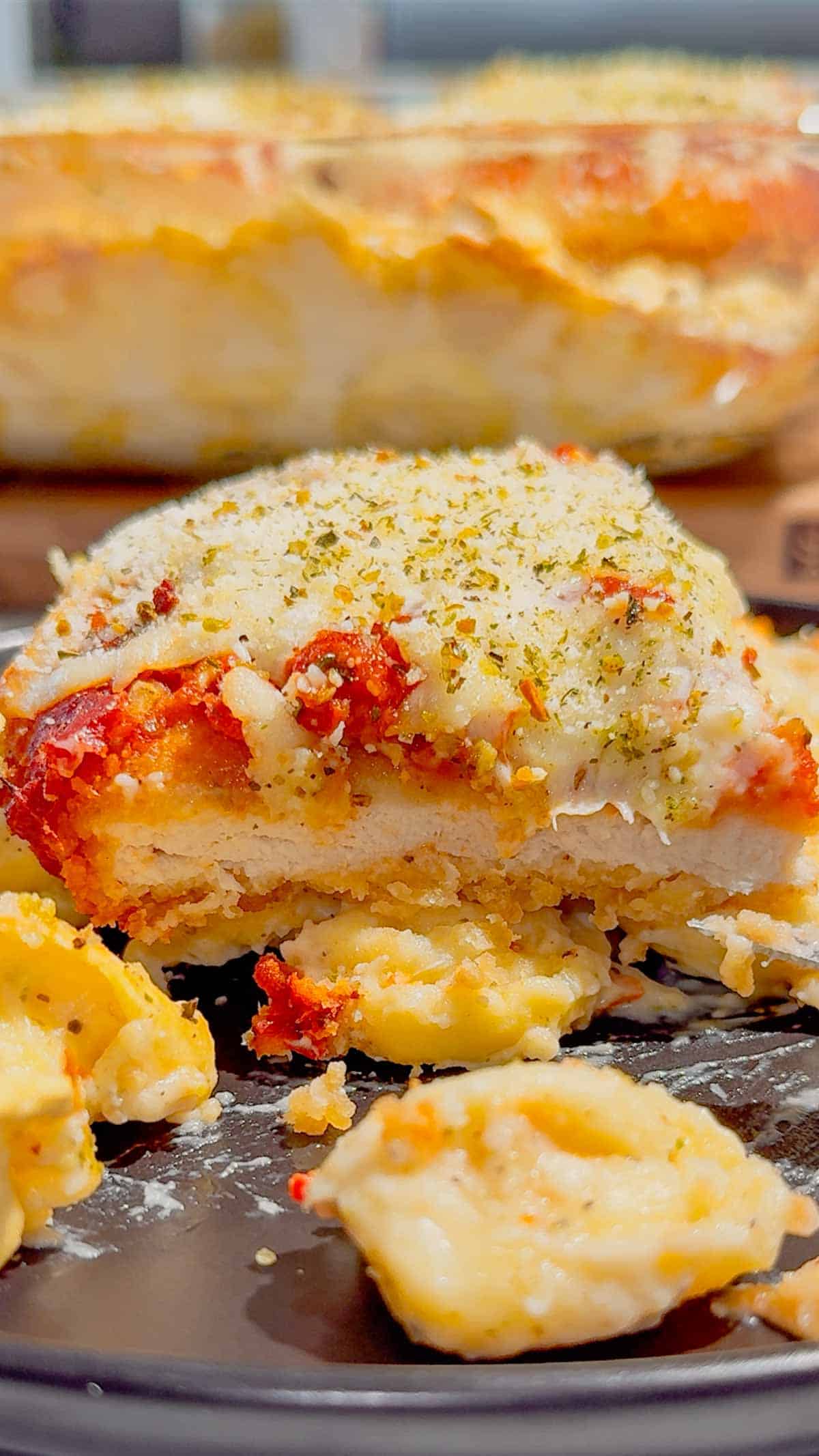 This Dump and Bake Chicken Parm Tortellini Alfredo is the ultimate easy comfort food dinner for busy weeknights, lazy dinners and family meals everyone will love. Made with refrigerated cheese and bacon tortellini, creamy jarred Alfredo sauce, crispy breaded chicken burgers, rich marinara sauce and gooey melted mozzarella, this baked pasta casserole comes together in one dish with almost no prep. If you love easy chicken parm recipes, dump dinners, baked tortellini recipes, cheesy pasta casseroles and simple family dinner ideas, this recipe is a must-try. Perfect for quick weeknight dinners, freezer meals, potlucks and cozy comfort food cravings, this creamy chicken parmesan tortellini bake is loaded with flavour, cheesy layers and hearty pasta goodness in every bite.