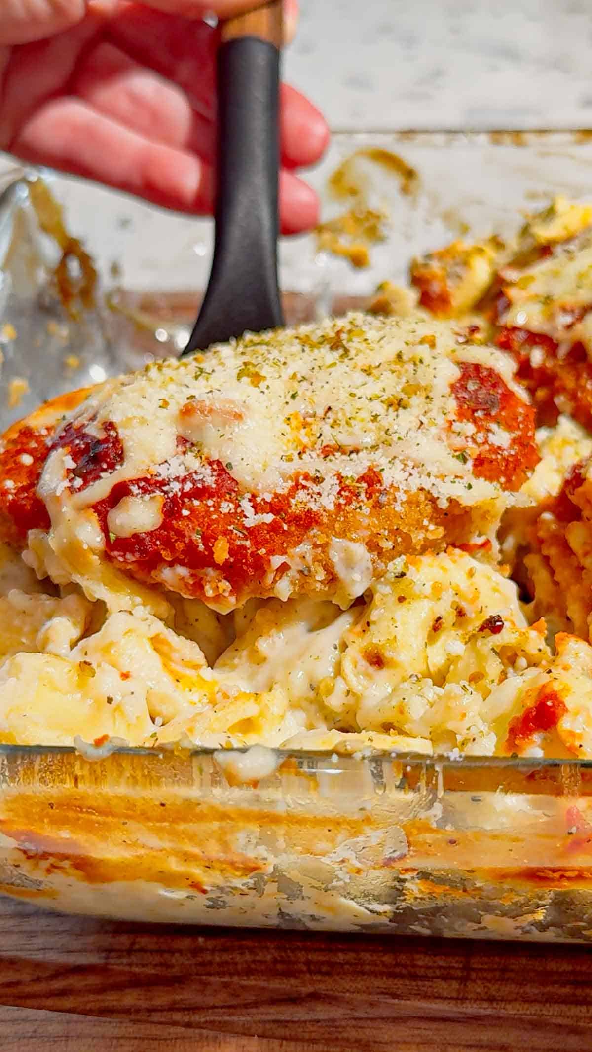 This Dump and Bake Chicken Parm Tortellini Alfredo is the ultimate easy comfort food dinner for busy weeknights, lazy dinners and family meals everyone will love. Made with refrigerated cheese and bacon tortellini, creamy jarred Alfredo sauce, crispy breaded chicken burgers, rich marinara sauce and gooey melted mozzarella, this baked pasta casserole comes together in one dish with almost no prep. If you love easy chicken parm recipes, dump dinners, baked tortellini recipes, cheesy pasta casseroles and simple family dinner ideas, this recipe is a must-try. Perfect for quick weeknight dinners, freezer meals, potlucks and cozy comfort food cravings, this creamy chicken parmesan tortellini bake is loaded with flavour, cheesy layers and hearty pasta goodness in every bite.