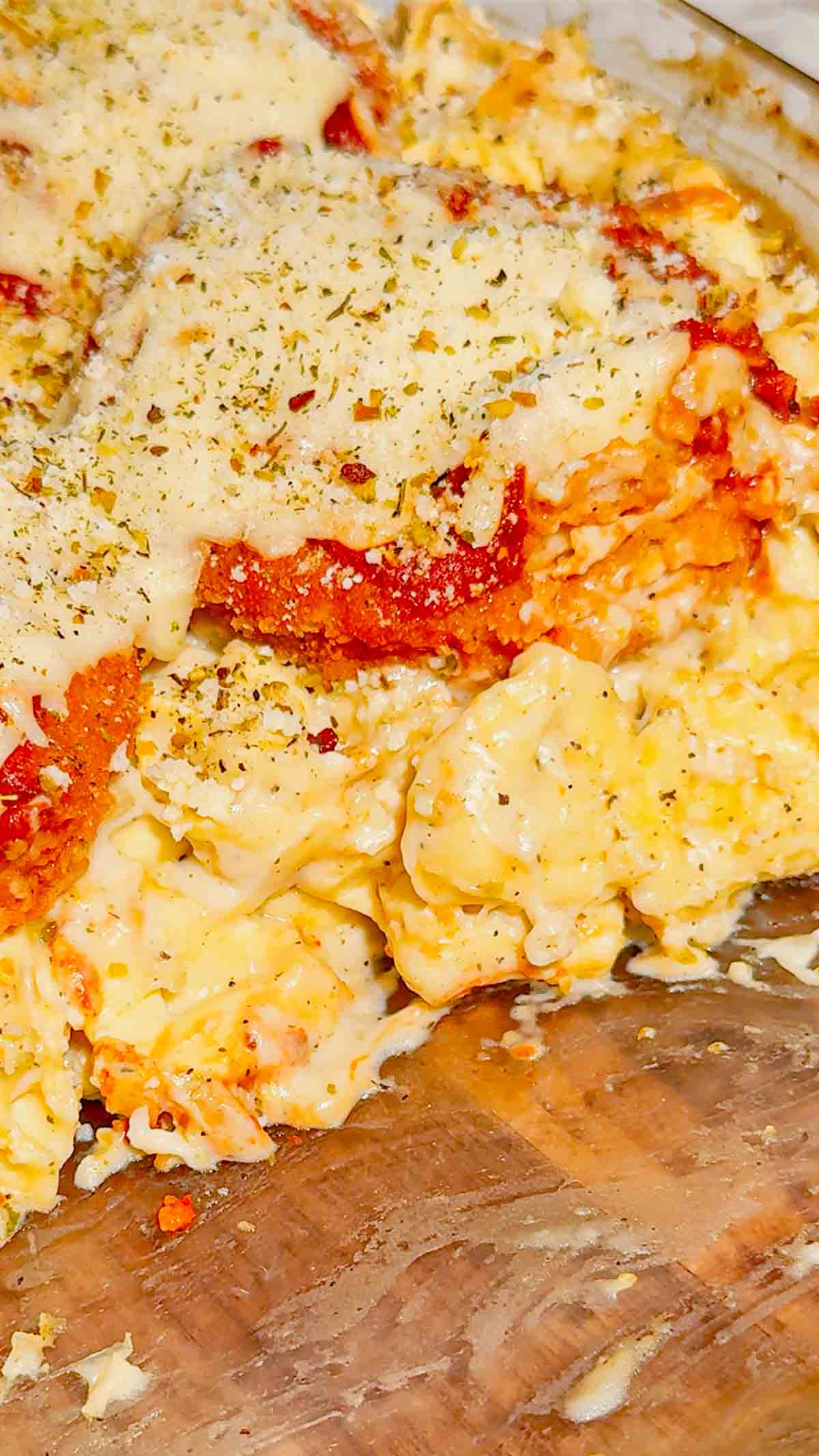 This Dump and Bake Chicken Parm Tortellini Alfredo is the ultimate easy comfort food dinner for busy weeknights, lazy dinners and family meals everyone will love. Made with refrigerated cheese and bacon tortellini, creamy jarred Alfredo sauce, crispy breaded chicken burgers, rich marinara sauce and gooey melted mozzarella, this baked pasta casserole comes together in one dish with almost no prep. If you love easy chicken parm recipes, dump dinners, baked tortellini recipes, cheesy pasta casseroles and simple family dinner ideas, this recipe is a must-try. Perfect for quick weeknight dinners, freezer meals, potlucks and cozy comfort food cravings, this creamy chicken parmesan tortellini bake is loaded with flavour, cheesy layers and hearty pasta goodness in every bite.