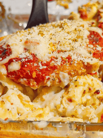 This Dump and Bake Chicken Parm Tortellini Alfredo is the ultimate easy comfort food dinner for busy weeknights, lazy dinners and family meals everyone will love. Made with refrigerated cheese and bacon tortellini, creamy jarred Alfredo sauce, crispy breaded chicken burgers, rich marinara sauce and gooey melted mozzarella, this baked pasta casserole comes together in one dish with almost no prep. If you love easy chicken parm recipes, dump dinners, baked tortellini recipes, cheesy pasta casseroles and simple family dinner ideas, this recipe is a must-try. Perfect for quick weeknight dinners, freezer meals, potlucks and cozy comfort food cravings, this creamy chicken parmesan tortellini bake is loaded with flavour, cheesy layers and hearty pasta goodness in every bite.