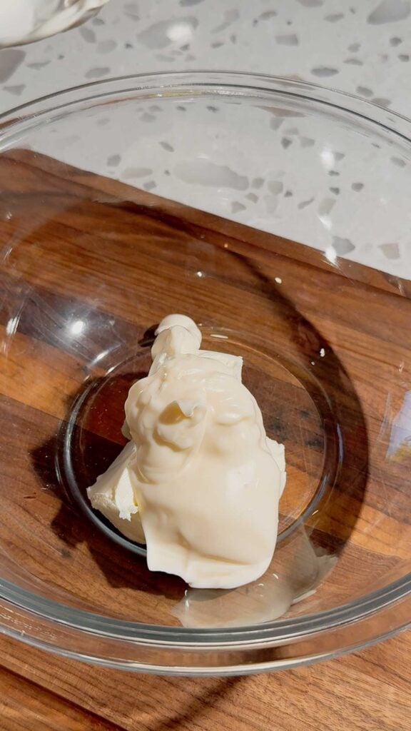 mayo and softened cream cheese cubes in a glass bolw