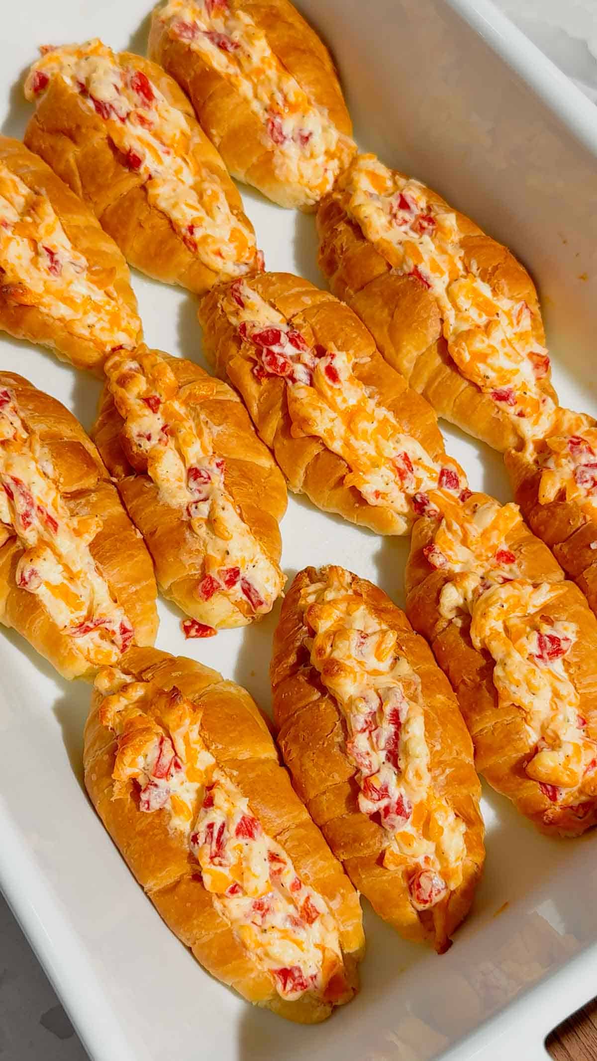 These Pimento Cheese Mini Croissants are the ultimate easy party appetizer for holidays, game day spreads, brunch tables and casual entertaining. Mini butter croissants are sliced open and stuffed with creamy homemade pimento cheese made with sharp cheddar, mayo, cream cheese and diced pimentos, then baked until warm, melty and golden brown. These cheesy baked croissant sandwiches are rich, buttery and packed with bold Southern-inspired flavour in every bite. Perfect for make ahead entertaining, easy finger foods, football snacks, brunch recipes, appetizer trays and quick baked party food ideas. If you love easy croissant recipes, cheesy appetizers, baked sandwiches and crowd pleasing snacks, this easy recipe is a must try.