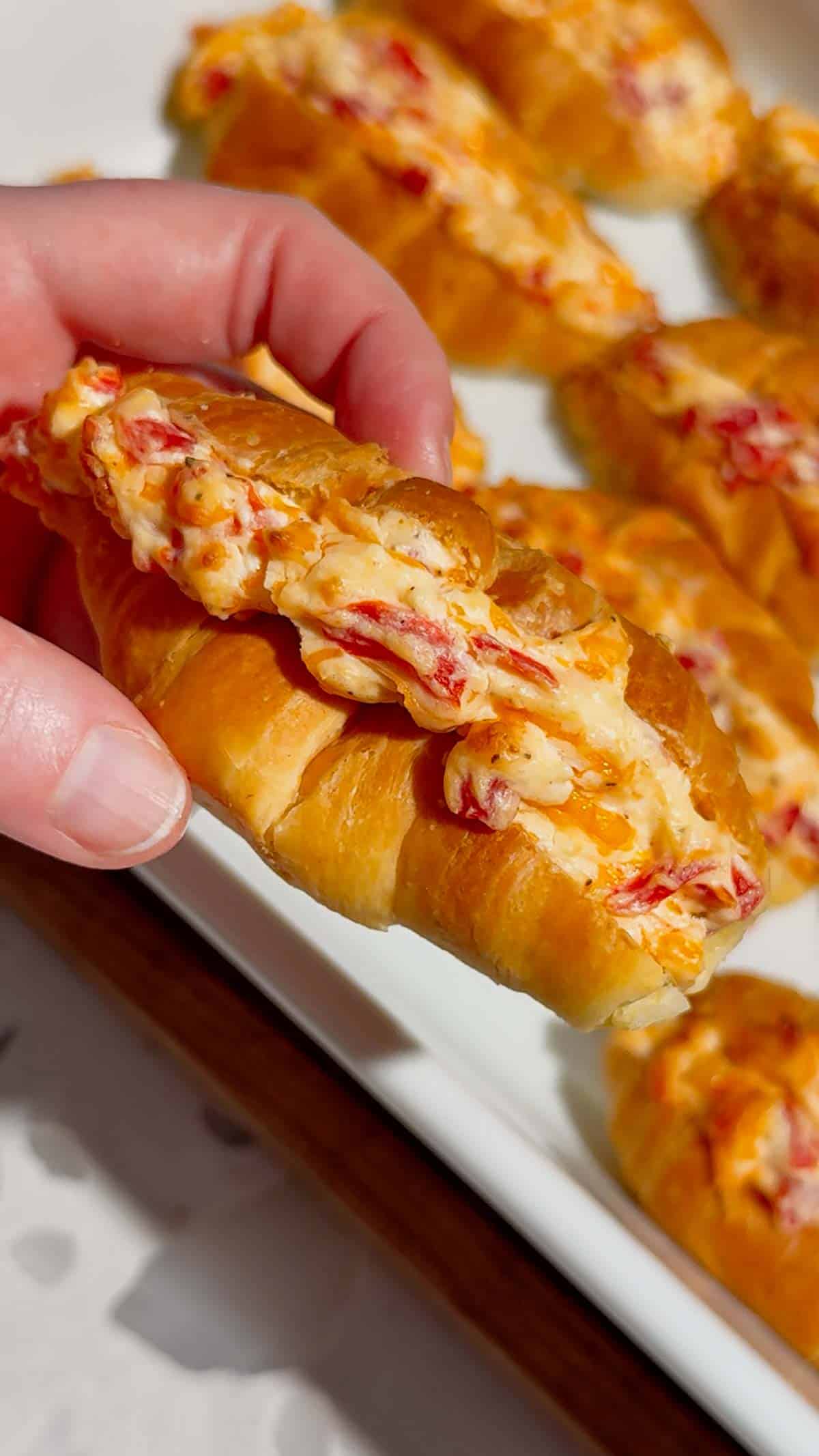 These Pimento Cheese Mini Croissants are the ultimate easy party appetizer for holidays, game day spreads, brunch tables and casual entertaining. Mini butter croissants are sliced open and stuffed with creamy homemade pimento cheese made with sharp cheddar, mayo, cream cheese and diced pimentos, then baked until warm, melty and golden brown. These cheesy baked croissant sandwiches are rich, buttery and packed with bold Southern-inspired flavour in every bite. Perfect for make ahead entertaining, easy finger foods, football snacks, brunch recipes, appetizer trays and quick baked party food ideas. If you love easy croissant recipes, cheesy appetizers, baked sandwiches and crowd pleasing snacks, this easy recipe is a must try.