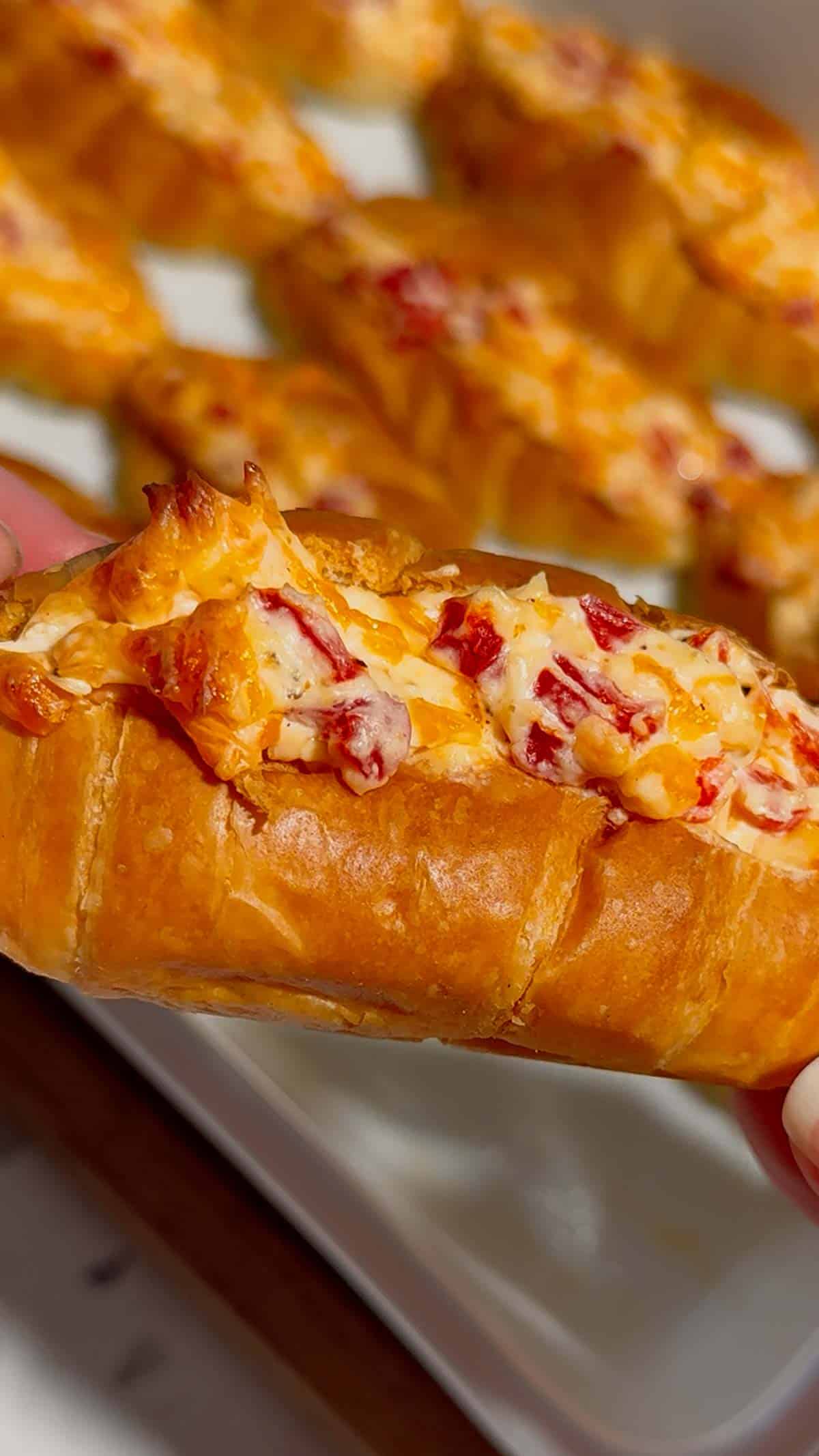 These Pimento Cheese Mini Croissants are the ultimate easy party appetizer for holidays, game day spreads, brunch tables and casual entertaining. Mini butter croissants are sliced open and stuffed with creamy homemade pimento cheese made with sharp cheddar, mayo, cream cheese and diced pimentos, then baked until warm, melty and golden brown. These cheesy baked croissant sandwiches are rich, buttery and packed with bold Southern-inspired flavour in every bite. Perfect for make ahead entertaining, easy finger foods, football snacks, brunch recipes, appetizer trays and quick baked party food ideas. If you love easy croissant recipes, cheesy appetizers, baked sandwiches and crowd pleasing snacks, this easy recipe is a must try.