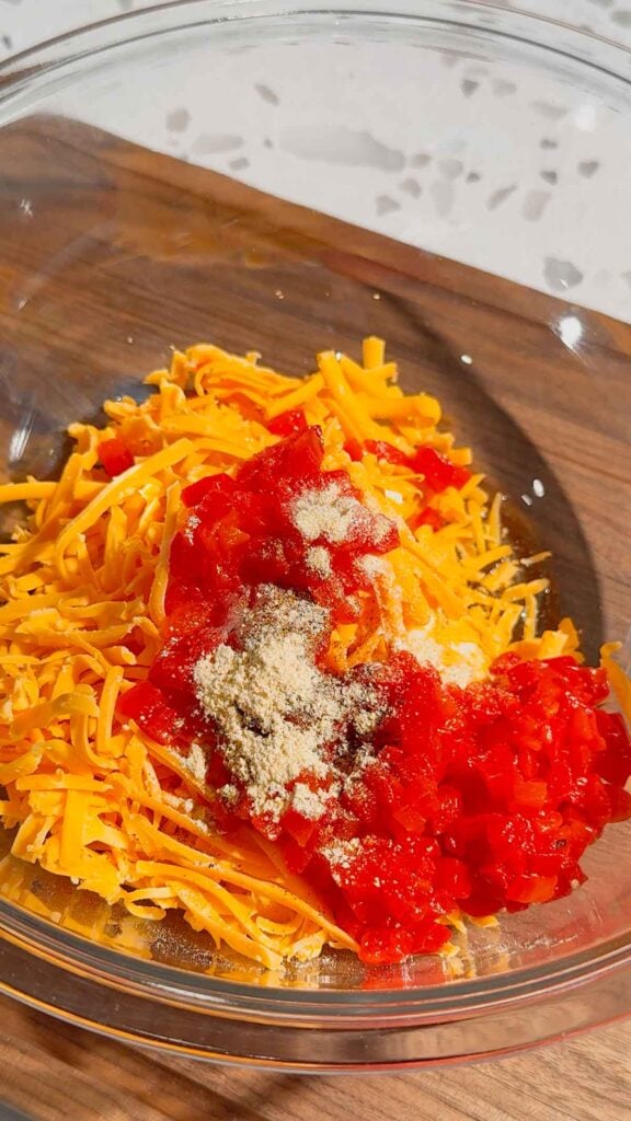spices, diced pimentos and cheddar cheese in a mixing bowl.