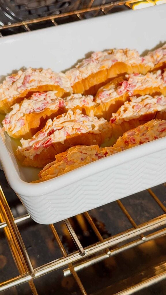 pimento cheese stuffed croissants in a baking dish in the oven