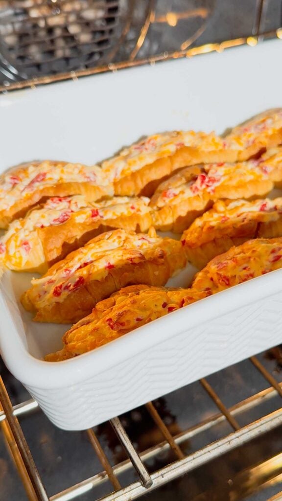 pimento cheese stuffed croissants baking in the oven until golden