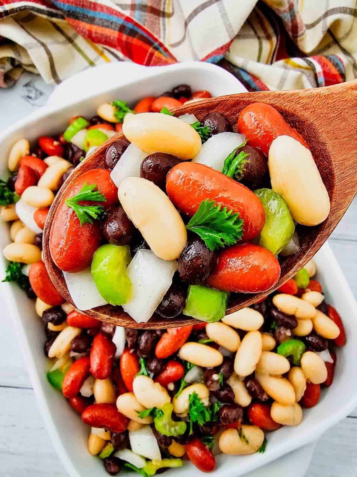 Looking for the perfect Three Bean Salad Recipe to serve at your next barbecue, picnic, or potluck? This easy Classic Three Bean Salad is loaded with kidney beans, cannellini beans, black beans, crisp celery, onion, fresh parsley, and a sweet tangy homemade dressing. It's one of the best Cold Bean Salad Recipes because it's quick to make, packed with protein and fiber, and tastes even better after chilling. Whether you need Summer Side Dishes, BBQ Side Dishes, Picnic Food Ideas, Potluck Side Dishes, Healthy Bean Salad, Make Ahead Salad Recipes, or easy Cookout Side Dishes, this fresh and flavorful bean salad is a crowd-pleasing favorite that's perfect for family dinners, holidays, and warm weather entertaining.