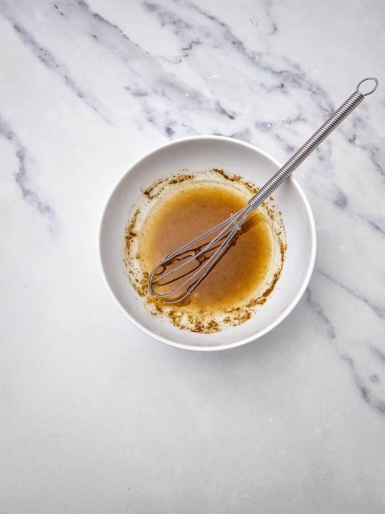 whisking homemade dressing in a bowl