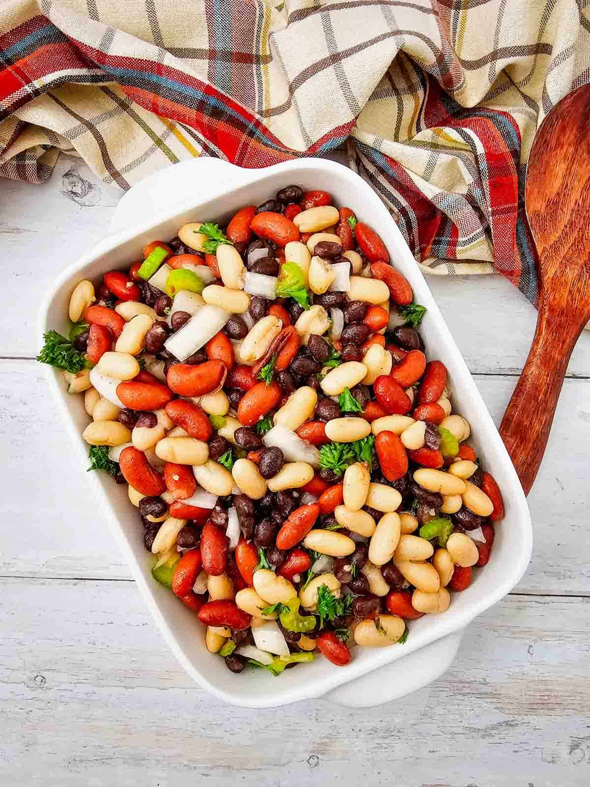 Looking for the perfect Three Bean Salad Recipe to serve at your next barbecue, picnic, or potluck? This easy Classic Three Bean Salad is loaded with kidney beans, cannellini beans, black beans, crisp celery, onion, fresh parsley, and a sweet tangy homemade dressing. It's one of the best Cold Bean Salad Recipes because it's quick to make, packed with protein and fiber, and tastes even better after chilling. Whether you need Summer Side Dishes, BBQ Side Dishes, Picnic Food Ideas, Potluck Side Dishes, Healthy Bean Salad, Make Ahead Salad Recipes, or easy Cookout Side Dishes, this fresh and flavorful bean salad is a crowd-pleasing favorite that's perfect for family dinners, holidays, and warm weather entertaining.