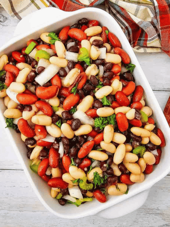 Looking for the perfect Three Bean Salad Recipe to serve at your next barbecue, picnic, or potluck? This easy Classic Three Bean Salad is loaded with kidney beans, cannellini beans, black beans, crisp celery, onion, fresh parsley, and a sweet tangy homemade dressing. It's one of the best Cold Bean Salad Recipes because it's quick to make, packed with protein and fiber, and tastes even better after chilling. Whether you need Summer Side Dishes, BBQ Side Dishes, Picnic Food Ideas, Potluck Side Dishes, Healthy Bean Salad, Make Ahead Salad Recipes, or easy Cookout Side Dishes, this fresh and flavorful bean salad is a crowd-pleasing favorite that's perfect for family dinners, holidays, and warm weather entertaining.