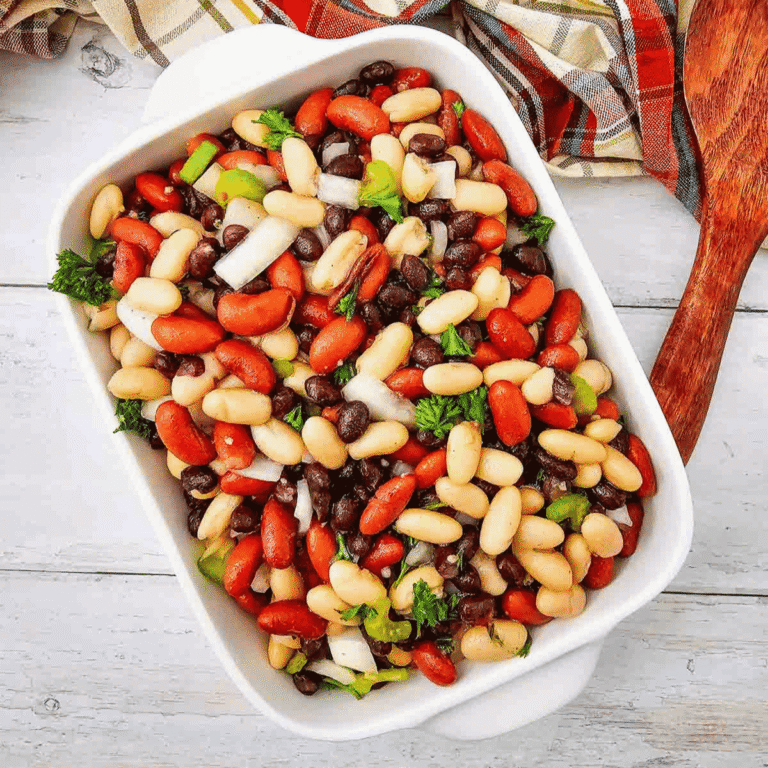 Looking for the perfect Three Bean Salad Recipe to serve at your next barbecue, picnic, or potluck? This easy Classic Three Bean Salad is loaded with kidney beans, cannellini beans, black beans, crisp celery, onion, fresh parsley, and a sweet tangy homemade dressing. It's one of the best Cold Bean Salad Recipes because it's quick to make, packed with protein and fiber, and tastes even better after chilling. Whether you need Summer Side Dishes, BBQ Side Dishes, Picnic Food Ideas, Potluck Side Dishes, Healthy Bean Salad, Make Ahead Salad Recipes, or easy Cookout Side Dishes, this fresh and flavorful bean salad is a crowd-pleasing favorite that's perfect for family dinners, holidays, and warm weather entertaining.