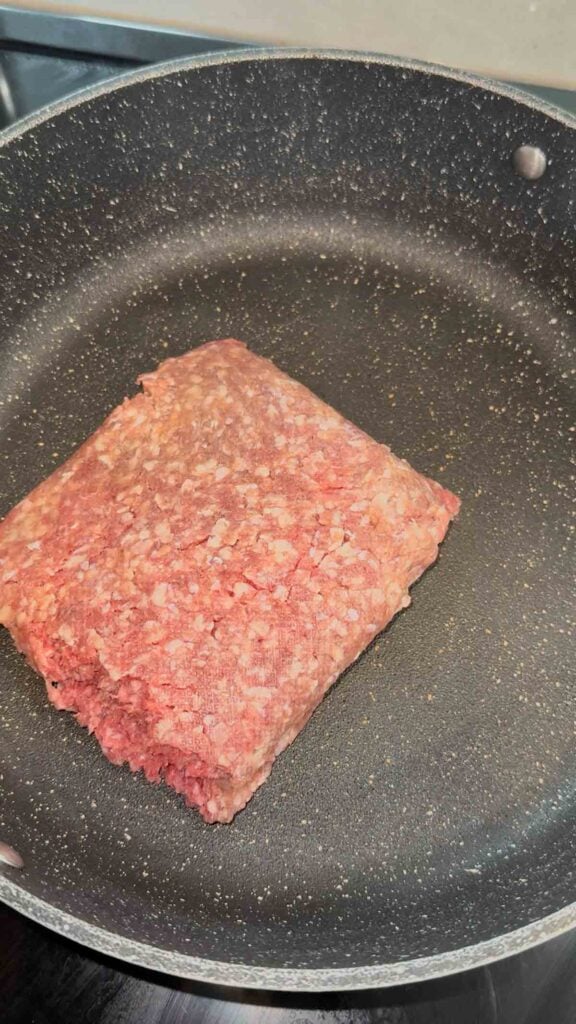 raw ground beef in a skillet