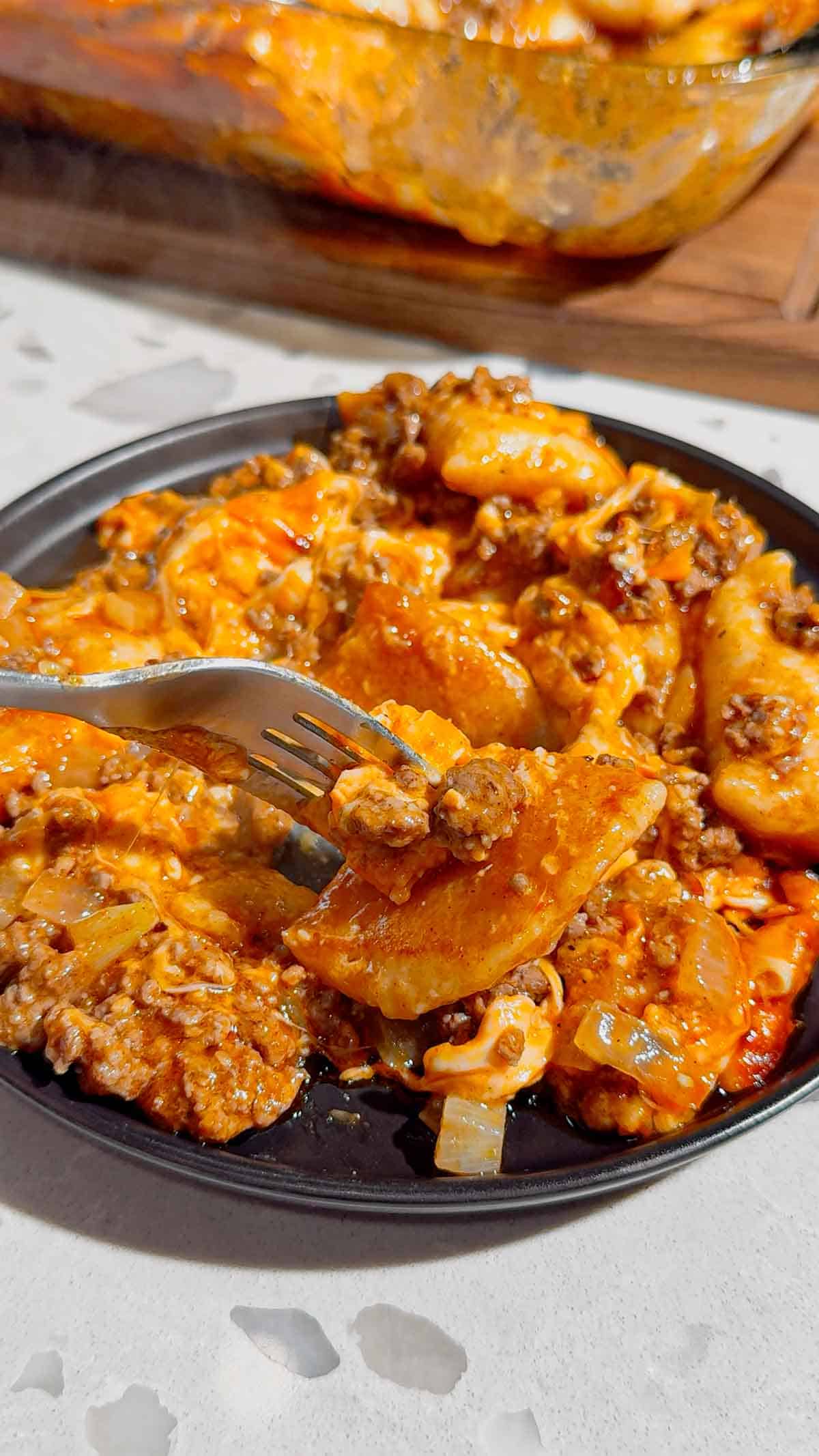 If you're looking for an easy comfort food dinner that combines Mexican-inspired flavors with hearty family-friendly ingredients, this Beef Enchilada Pierogies recipe is a must-try. Frozen pierogies are layered in a baking dish, topped with seasoned ground beef, rich red enchilada sauce, and plenty of melted cheddar cheese for a simple weeknight meal everyone will love. This easy casserole recipe is perfect for busy nights, potlucks, meal prep, and budget-friendly dinners. Whether you're searching for Ground Beef Dinner Recipes, Easy Casserole Recipes, Enchilada Casserole Ideas, Pierogi Casserole Recipes, Frozen Pierogies Recipes, or Cheesy Beef Bakes, this recipe delivers big flavor with minimal effort. The combination of tender potato-filled pierogies, savory beef, zesty enchilada sauce, and gooey cheese creates the ultimate comfort food casserole. Save this Easy Beef Enchilada Pierogies Bake for quick family dinners, freezer meals, cozy weeknight suppers, and crowd-pleasing comfort food recipes that are guaranteed to disappear fast.