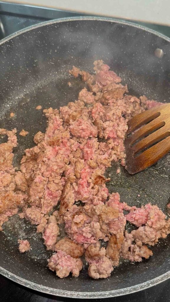 ground beef cooking in a skillet