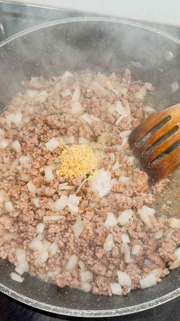 minced garlic, salt and pepper added to skillet with cooked ground beef and diced onions