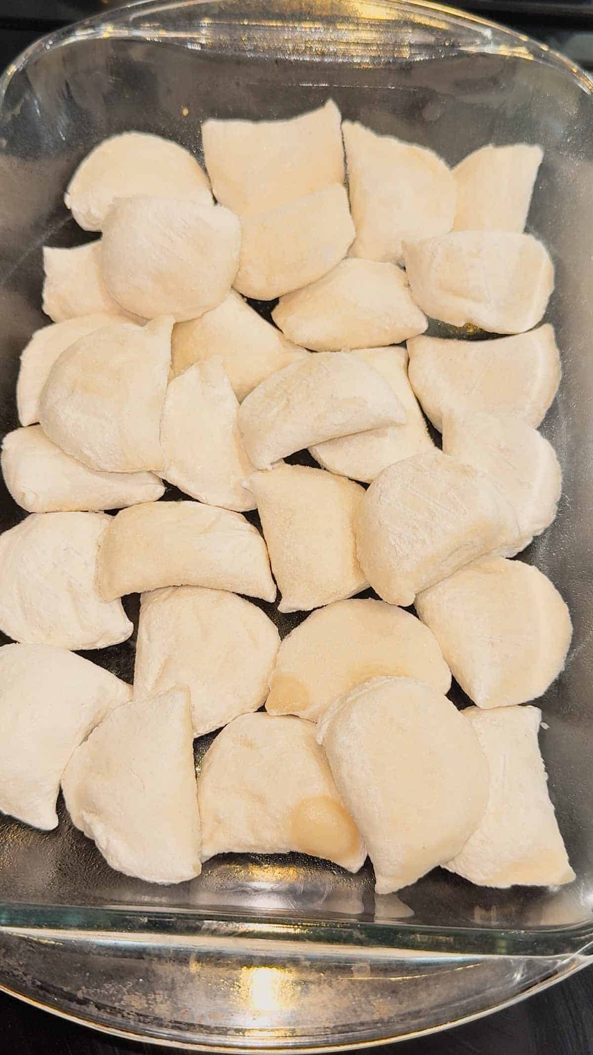 frozen pierogies in a glass 9 x 13 inch baking dish