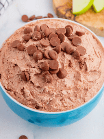 Craving chocolate but don’t feel like baking? This Brownie Batter Dip is the ultimate no-bake dessert that comes together in just 5 minutes with cream cheese, Cool Whip, brownie mix, and mini chocolate chips. Rich, creamy, and packed with classic brownie batter flavor, this easy dessert dip is perfect for parties, game day spreads, movie nights, holiday gatherings, and last-minute sweet cravings. Serve it with graham crackers, vanilla wafers, pretzels, strawberries, apple slices, or cookies for an irresistible treat everyone will love. If you're looking for easy dessert recipes, chocolate dip recipes, no bake desserts, brownie batter desserts, party food ideas, and quick sweet treats, this crowd-pleasing dip is guaranteed to disappear fast. Save this simple brownie batter dip recipe for your next celebration!